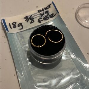 18g 3/8 (10mm) Yellow gold fixed bead hoop and rose gold clicker.